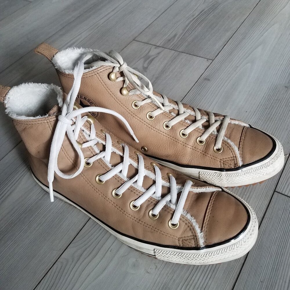Tan leather and faux fur lined Converse high top lace up shoes